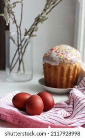 Easter Eggs On A Cotton Napkin And Easter Cake In The Background. Eggs Dyed With Natural Onions On A Rustic White Window Background. Natural Ecological Coloring With Food Coloring. View From Above.