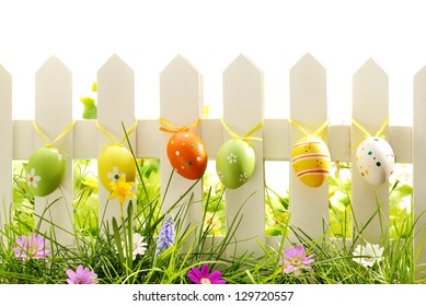 Easter eggs on fence with spring flowers - Powered by Shutterstock