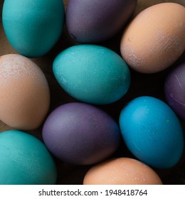 Easter Eggs In Pale Orange, Turquoise, Purple, And Blue.