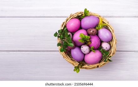 Easter eggs  purple   lilac   white wooden table  Easter card  banner  selective focus  horizontal