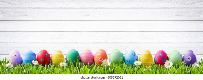 Easter Eggs In A Row And White Wooden Background
