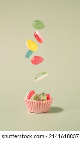 Easter Eggs Soft Candy Falling In The Pastel Pink Paper Cup. Happy Easter Minimal Background