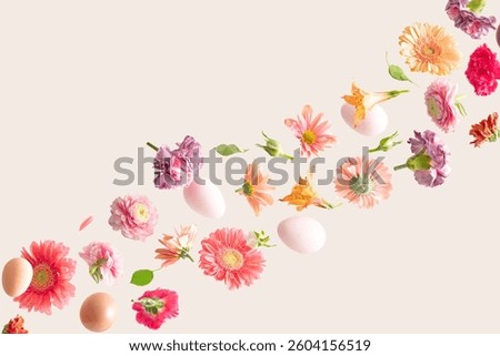 Easter eggs and Spring flowers against a cream background. Colorful background concept for different purposes with copy space.