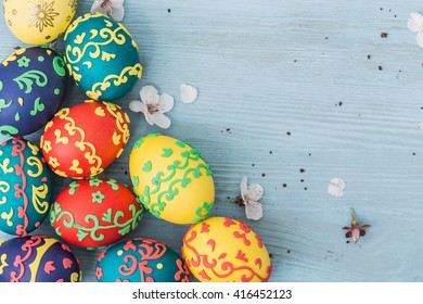 Easter eggs and spring flowers on wooden background - Shutterstock ID 416452123