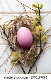 Easter eggs in the straw on a light background. Top view.