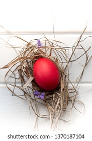 Easter eggs in the straw on a light background. Top view.