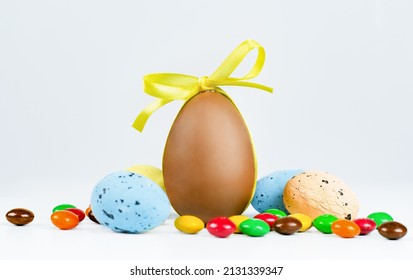 Easter eggs and sweets on a light background