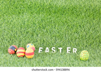 Easter eggs with text easter on green grass