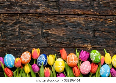 Easter Eggs And Tulips On Wooden Planks
