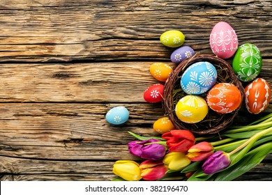 Easter Eggs And Tulips On Wooden Planks