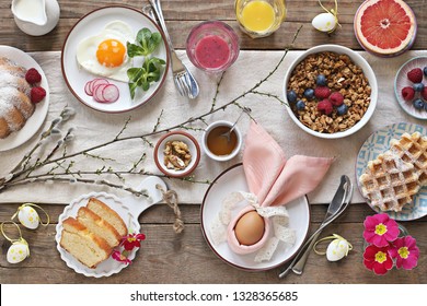 Easter Festive Breakfast Or Brunch Set Served On Rustic Wooden Table. Overhead View, Copy Space