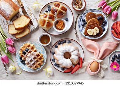 Easter Festive Dessert Table With Hot Cross Buns, Cakes, Waffles And Pancakes. Overhead View