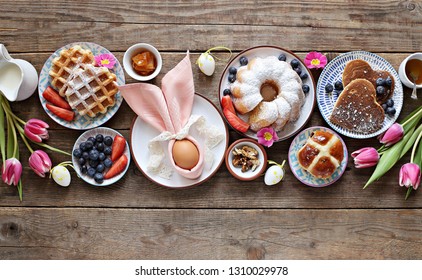 Easter Festive Dessert Table With Hot Cross Buns, Cakes, Waffles And Pancakes. Overhead View