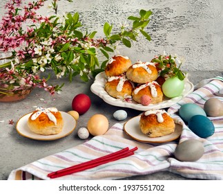 Easter Festive Dessert Table With Hot Cross Buns And Painted Easter Eggs On Linen Table Cloth. Overhead View
