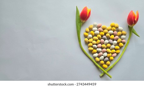 ​An Easter Flat Lay Of Two Red Tulips Framing A Heart Of Speckled Mini Eggs With White Space