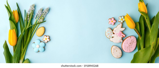 Easter floral background, various gingerbread glazed cookies end decorated with natural botanical elements on blue, flat lay, view from above, blank space for greeting text, banner, flyer, coupon - Powered by Shutterstock