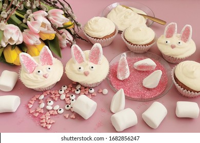 Easter Food Concept. Idea For Kids. Decorating  Easter Bunny Cupcakes With Marshmallow And Nonpareils