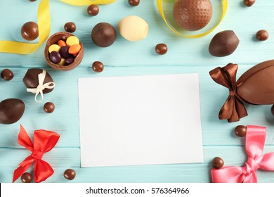 Easter Frame With Chocolate Sweets On Color Wooden Background