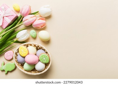 Easter frame with eggs, gift box and tulip on a colored background. The minimal concept. Top view Happy Easter composition. Card with a copy space of the place for the text. - Shutterstock ID 2279012043