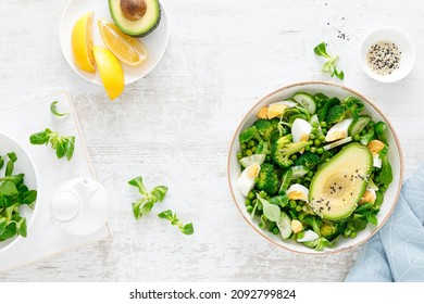 Easter Fresh Vegetable Salad With Boiled Egg, Broccoli, Corn Salad, Green Peas And Avocado, Top View