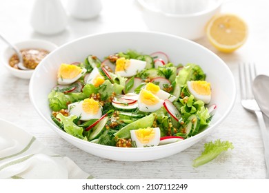 Easter Fresh Vegetable Salad With Boiled Egg, Radish And Cucumber, Dressing With Dijon Mustard And Lemon On White Wooden Table