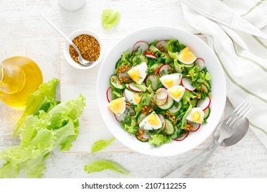 Easter Fresh Vegetable Salad With Boiled Egg, Radish And Cucumber, Dressing With Dijon Mustard And Lemon On White Wooden Table. Top View