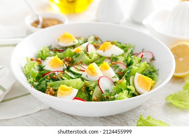 Easter Fresh Vegetable Salad With Boiled Egg, Radish And Cucumber, Dressing With Dijon Mustard And Lemon On White Wooden Table