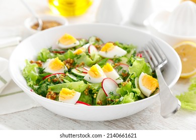 Easter Fresh Vegetable Salad With Boiled Egg, Radish And Cucumber, Dressing With Dijon Mustard And Lemon On White Wooden Table