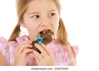 Easter: Girl Takes Bite Of Chocolate Bunny