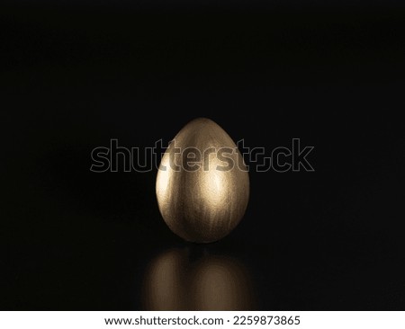 Easter, Gold birds eggs shot against a dark background	