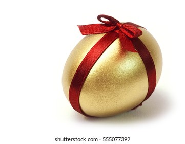 Easter Gold egg with red ribbon cross and bow on white background isolated.