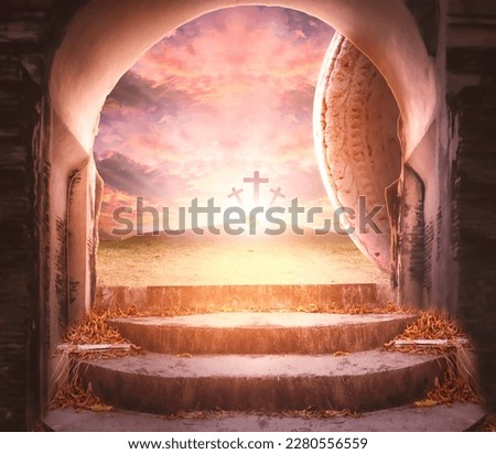 Easter and Good Friday concept, Empty tombstone with cross on mountain sunrise background