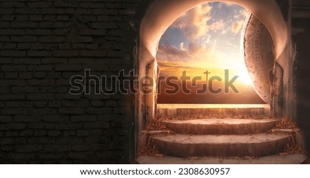 Easter and Good Friday concept, Empty tombstone with cross on mountain sunrise background