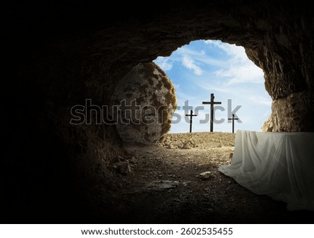 Easter and Good Friday concept, empty tomb with cross on mountain on a blue sky. Creative idea Easter. Religion and Christianity. Open empty cave. Free copy space for design