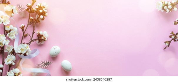 Easter greeting card with easter eggs and sprin flowers on pink table. Top view with space for your greetings - Image
