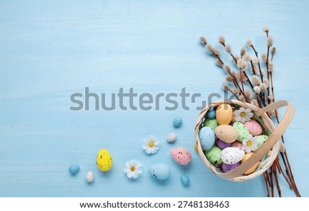 Easter greeting with painted egg in wicker basket and pussywillow branch arranged for elegant spring holiday celebration card design