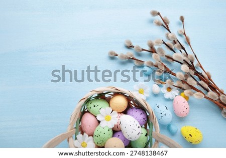 Easter greeting with painted egg in wicker basket and pussywillow branch arranged for elegant spring holiday celebration card design