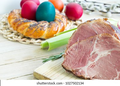 Easter Ham With Colorful Boiled Eggs And Sweet Bread  On Kitchen Table