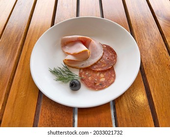 Easter Ham And Pepperoni In White Ceramic Dish On Wooden Table, Selective Focus. Pepperoni Is An American Variety Of Salami, Made From Cured Pork And Beef Seasoned With Paprika Or Other Chili Pepper