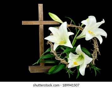 Easter Lily With Wooden Cross And Crown Of Thorns On A Black Background