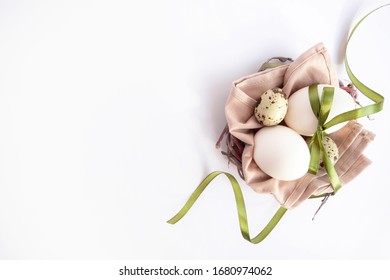 Easter nest with eggs and green ribbon on white background. Eco style easter. Flatlay - Powered by Shutterstock