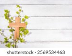 Easter orthodox catholic Christian  holiday background, with wooden cross symbol of religion, baking Easter cake with sugar icing, colored painted eggs and spring branches with blossoming leaves