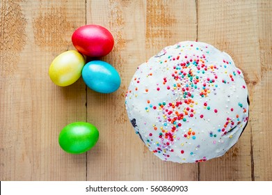 Easter Painted Eggs And Cake On Wooden Backdrop. Top View.