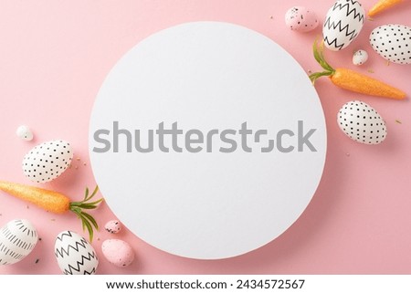 Easter project theme: Top view showcasing simple dyed eggs, sprinkles and orange carrots for the Easter Hare on a pale pink backdrop, with a vacant circular area for text