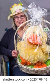 Easter Raffle
Disabled Lady In A Wheelchair Wearing An Easter Bonnet With A Raffle Prize Of A Large Easter Chick She Has Won.
