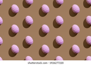 Easter seamless pattern. Festive decor. Holiday art. Abstract background. Pink painted paschal eggs with white zigzag lines isolated on beige.
