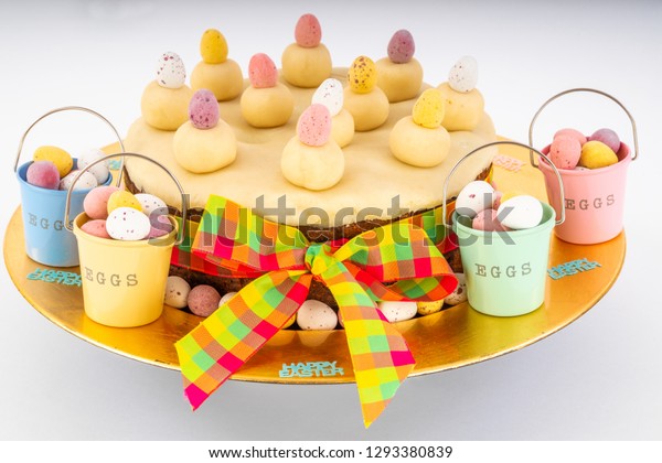 Easter Simnel Cake.\
Easter Simnel Cake with marzipan\
icing and eleven balls of marzipan representing the twelve Apostles\
minus Judas. with buckets of chocolate mini eggs  and Easter chicks\
round the b