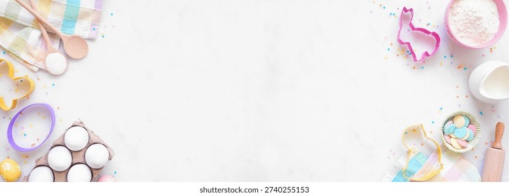 Easter or spring baking double border against a white marble banner background. Overhead view. Cookie cutters, eggs, and ingredients.