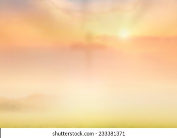 Easter Sunday concept: Blurred cross on nature sunrise background