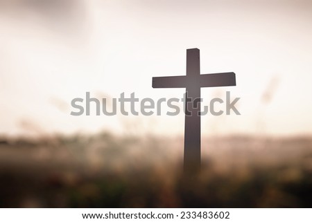 Easter Sunday concept: Silhouette wood cross on blurred abstract sky sunset background